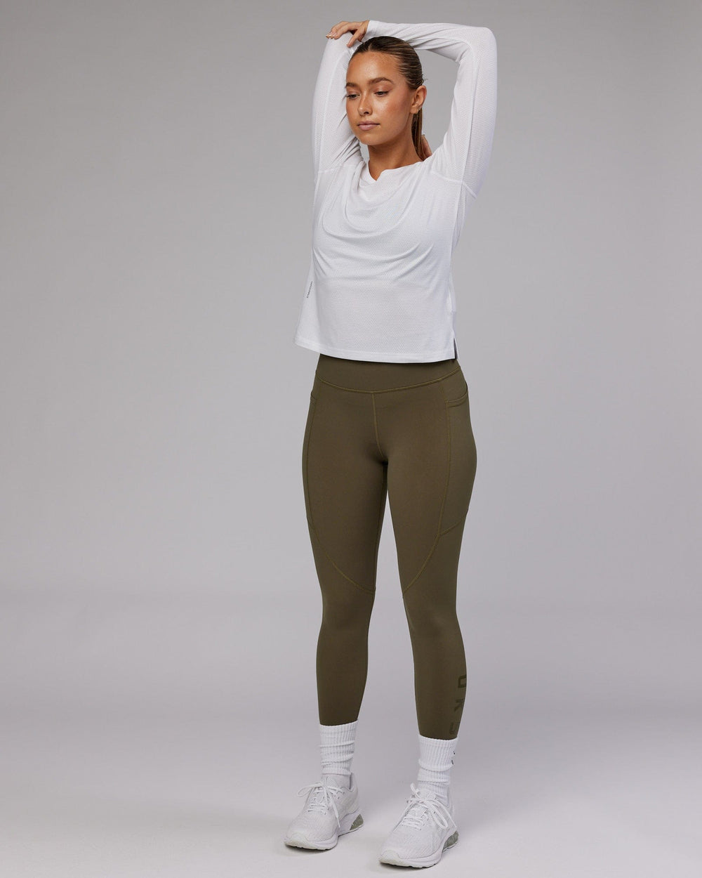 Woman wearing Perform VapourFLX LS Tee - White Marl