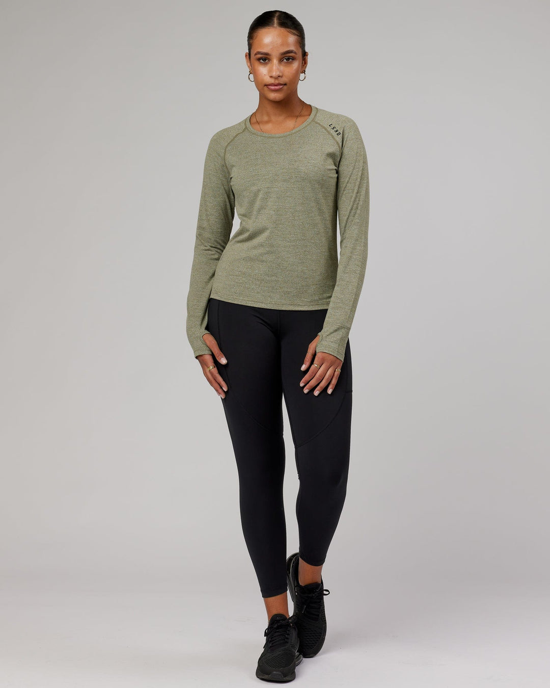 Woman wearing Olive Marl Perform VapourLFX Long Sleeve Tee