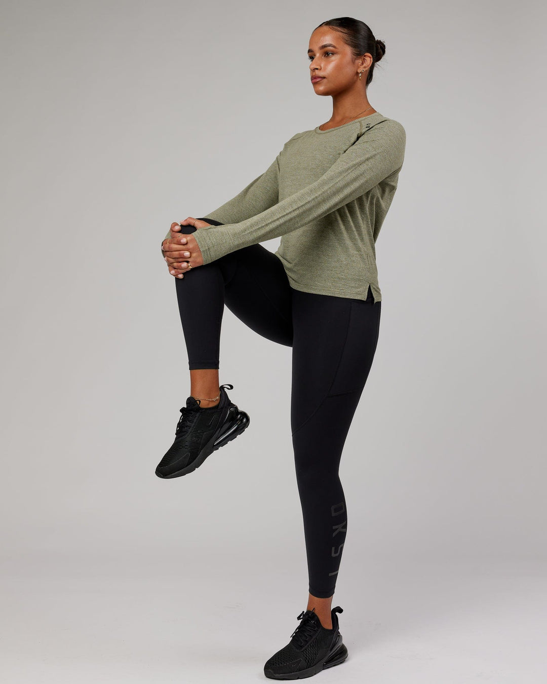 Woman wearing Olive Marl Perform VapourLFX Long Sleeve Tee