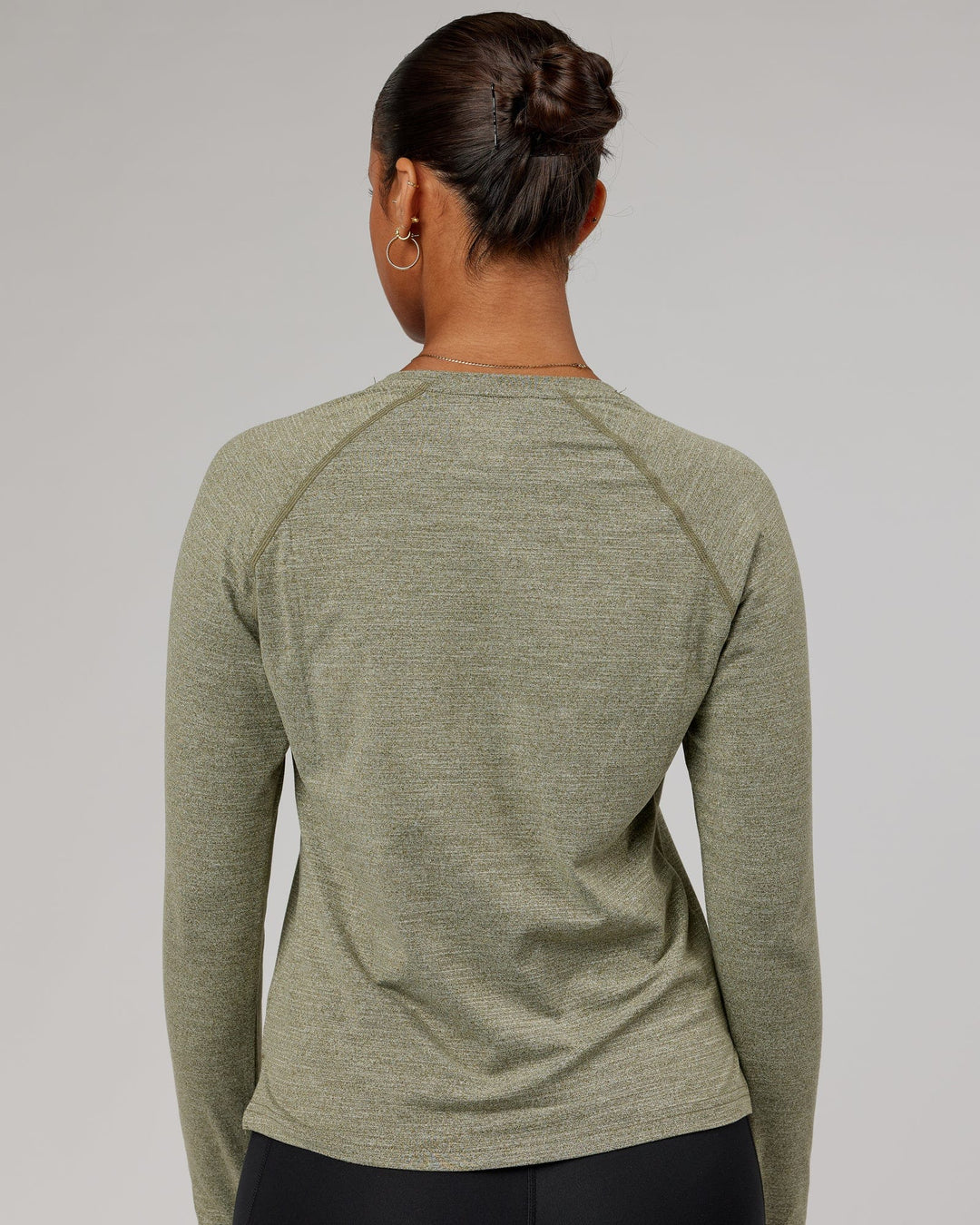 Woman wearing Olive Marl Perform VapourLFX Long Sleeve Tee