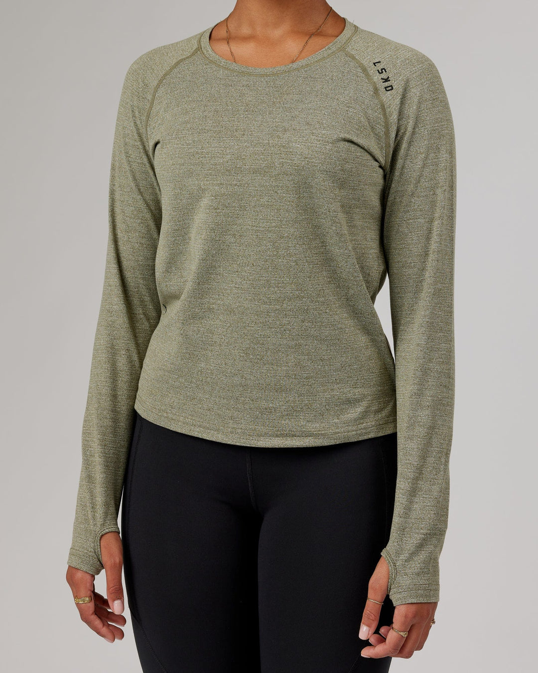 Woman wearing Olive Marl Perform VapourLFX Long Sleeve Tee
