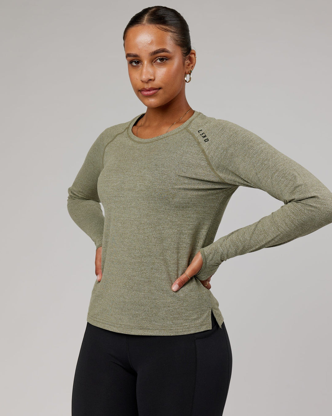 Woman wearing Olive Marl Perform VapourLFX Long Sleeve Tee