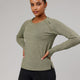 Woman wearing Olive Marl Perform VapourLFX Long Sleeve Tee
