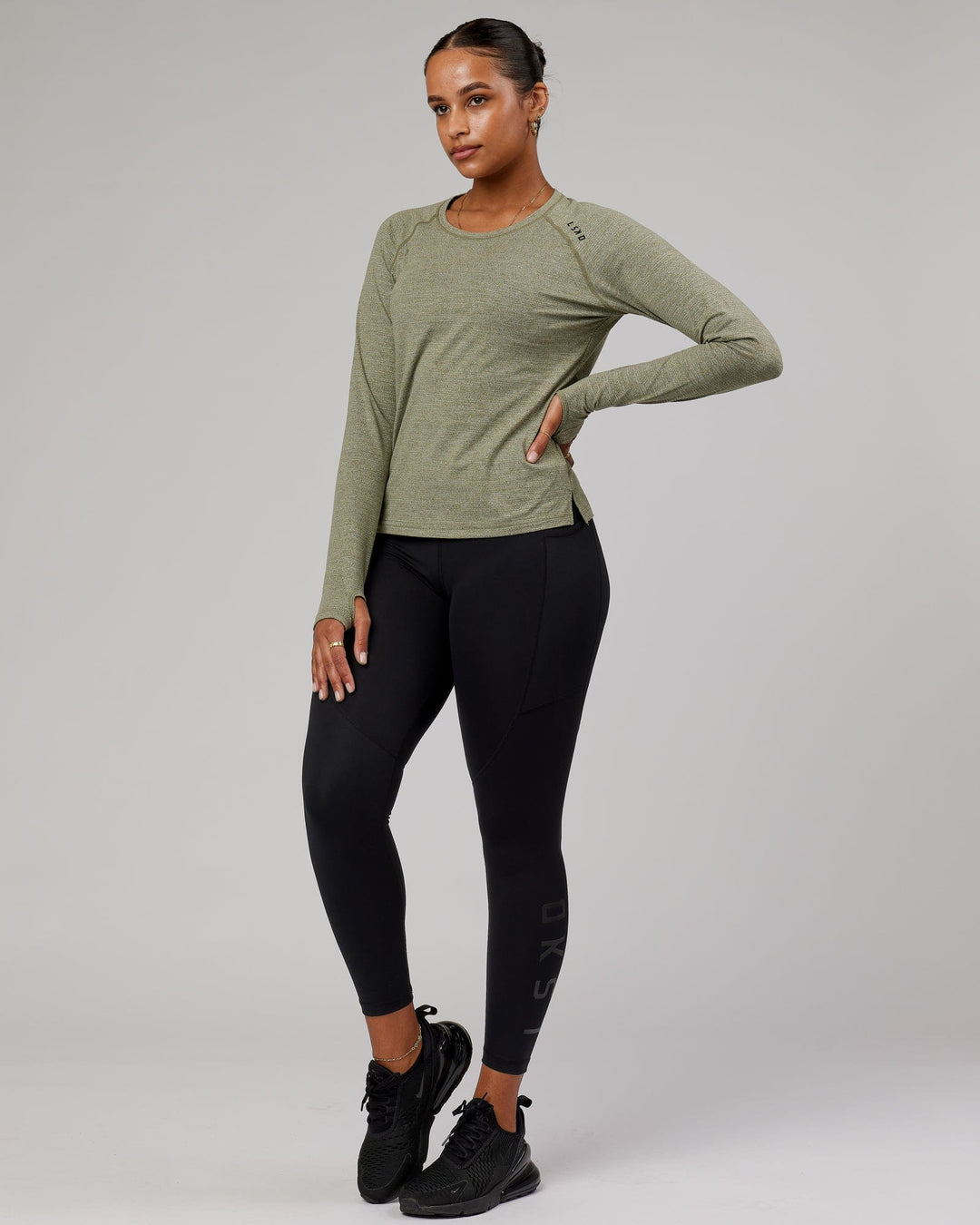 Woman wearing Olive Marl Perform VapourLFX Long Sleeve Tee