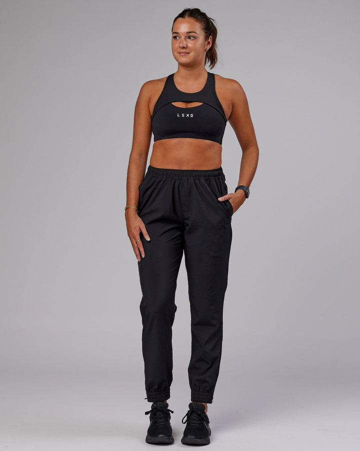 Woman wearing Warm Up Zip Cuff Performance Pant - Black