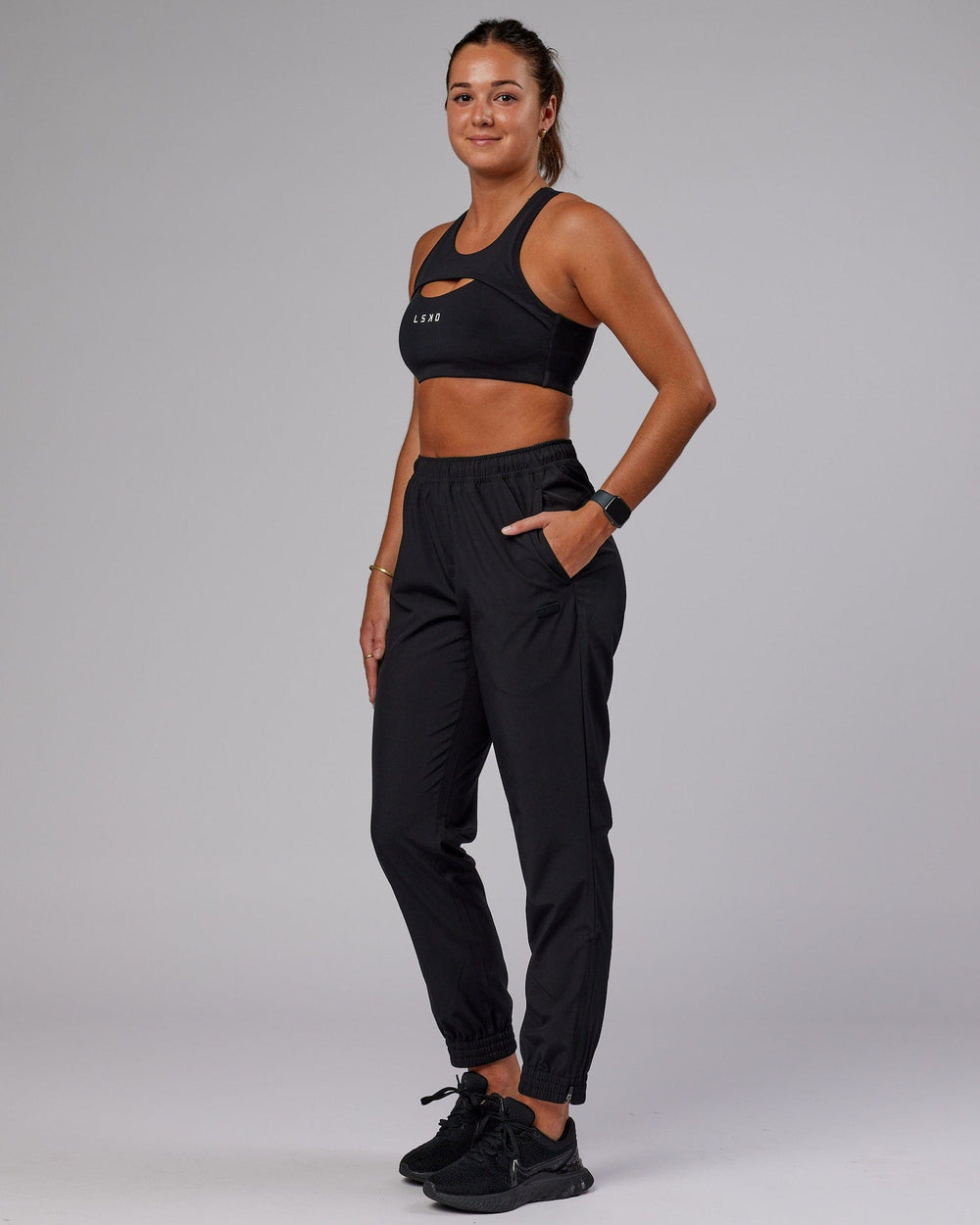 Woman wearing Warm Up Zip Cuff Performance Pant - Black