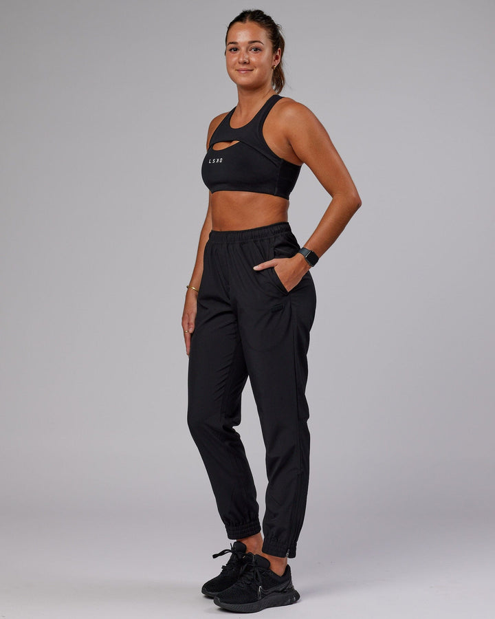Woman wearing Warm Up Zip Cuff Performance Pant - Black