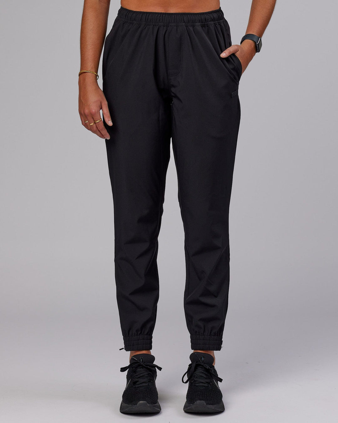 Woman wearing Warm Up Zip Cuff Performance Pant - Black