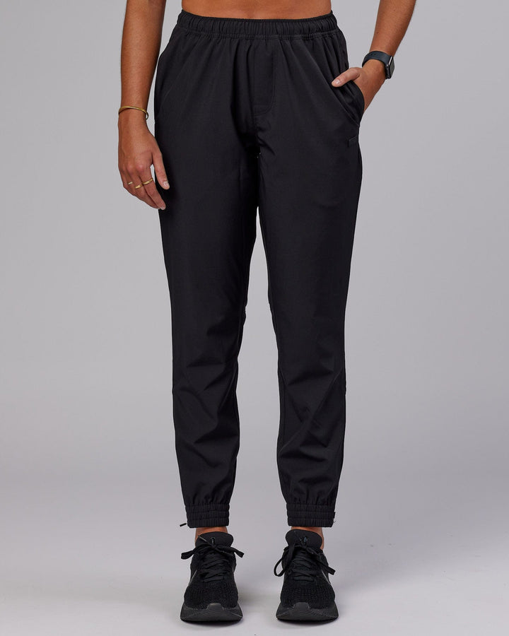 Woman wearing Warm Up Zip Cuff Performance Pant - Black