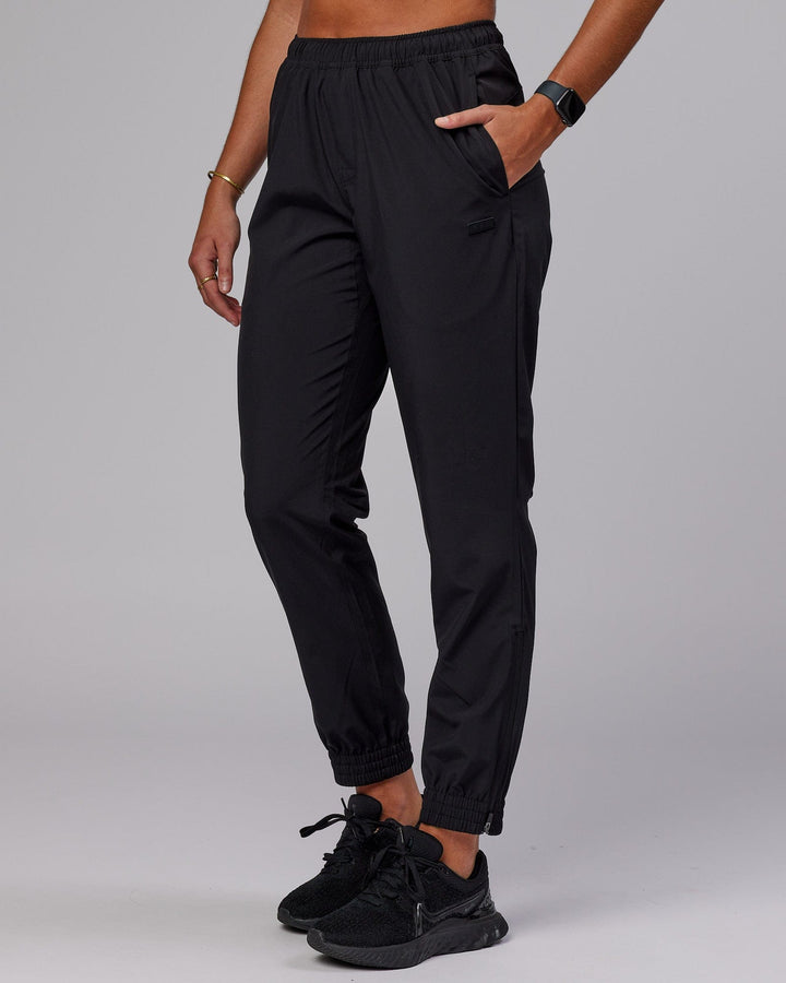 Woman wearing Warm Up Zip Cuff Performance Pant - Black