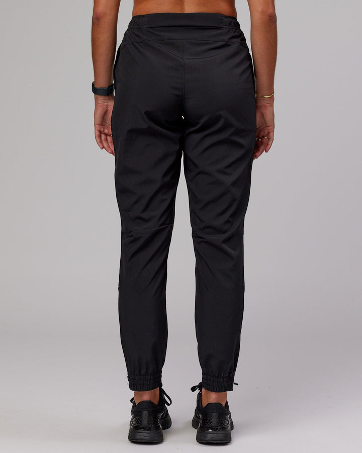 Woman wearing Warm Up Zip Cuff Performance Pant - Black